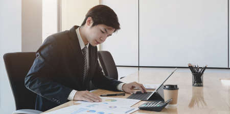 Professional businessman providing his investment strategy for the next meeting in his office roomの写真素材
