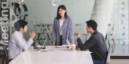 Young professional startup team consulting their marketing plan in the meeting roomの写真素材