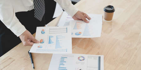Young professional businessman  preparing the financial reports for the meeting in his modern office roomの写真素材
