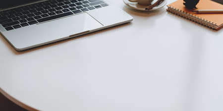 Modern workplace with laptop computer and office supplies on white table with copy spaceの写真素材