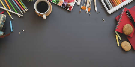 Trendy artist creative studio with copy space and painting tools and drawing equipment on grey background tableの写真素材