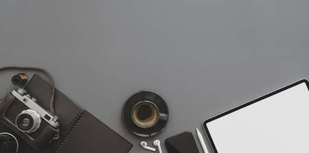 Trendy photographer workplace with copy space and office supplies on grey table backgroundの写真素材