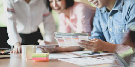 Cropped view of UI designer planing the UX application development with team members in modern workplaceの写真素材