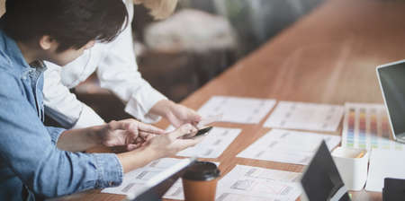 Cropped view of UI designer planing the UX application development with team members in modern workplaceの写真素材