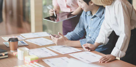 Cropped view of UI designer planing the UX application development with team members in modern workplaceの写真素材