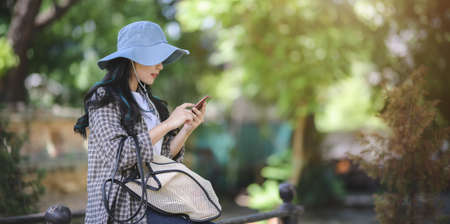 Young asian traveler taking the photo of the old temple while visiting the ancient historical places during the vacationの写真素材
