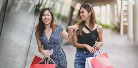 Young beautiful asian women enjoying their life by spending their time shopping at the luxury mallの写真素材