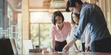 UX web developer team plaining the idea on smartphone application together in modern office roomの写真素材