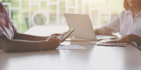 Close-up view of young professional UI web developer working on her project with blank screen laptop computerの写真素材