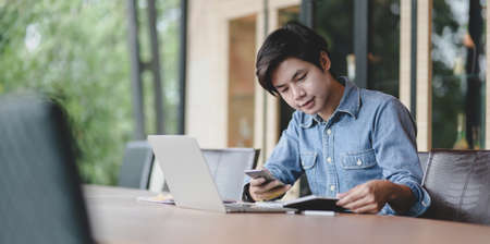Professional male UI web developer working on his project about UX templateの写真素材