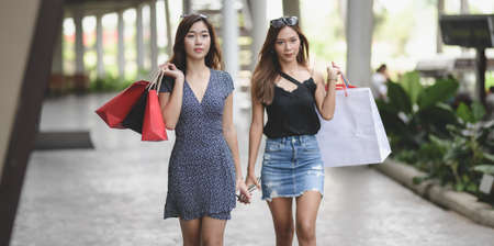 Young beautiful asian women enjoying their life by spending their time shopping at the luxury mallの写真素材