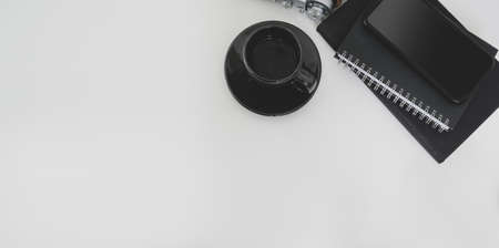 Overhead shot of minimal workplace and copy space with office supplies on white table backgroundの写真素材