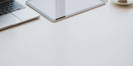 Top view of minimal workplace with copy space and supplies on white tableの写真素材