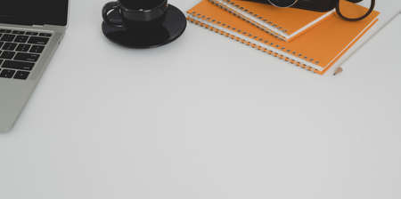 Overhead shot of minimal workplace and copy space with office supplies on white table desktopの写真素材