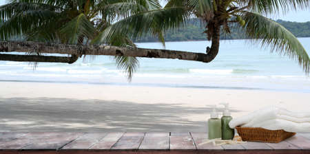 Empty rustic desk with copy space and coconut tree with beautiful tropical beacの写真素材