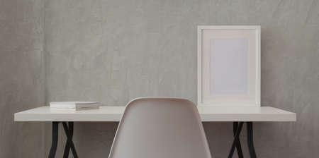 Loft workplace with white wooden desk and mock up frame and white book in grey wall backgroundの写真素材