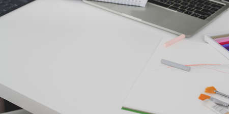 Cropped shot of minimal workplace with copy space, stationery and laptop computerの写真素材