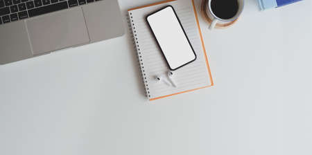 Top view of modern workplace with copy space on white wooden desk and office suppliesの写真素材
