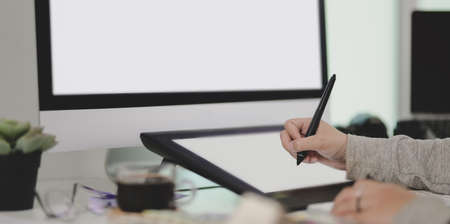 Cropped shot of graphic designer drawing her project on digital tablet in her comfortable workspaceの写真素材