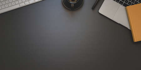 Top view of dark trendy workspace with office supplies with copy space on black backgroundの写真素材