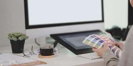 Cropped shot of young professional graphic designer choosing the colour for her projectの写真素材
