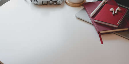 Cropped shot of contemporary workplace with copy space and office supplies on white wooden table backgroundの写真素材