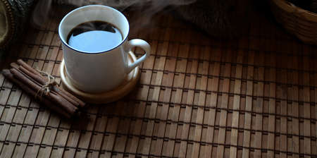 Close-up view of coffee cup on brown wooden desk background with copy spaceの写真素材