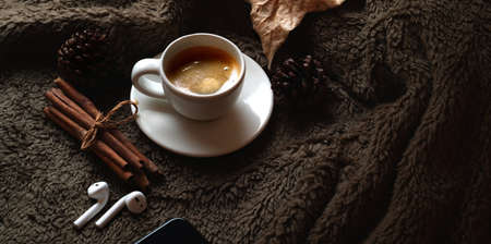 Close-up view of coffee cup with office supplies on brown fur desk background with copy spaceの写真素材