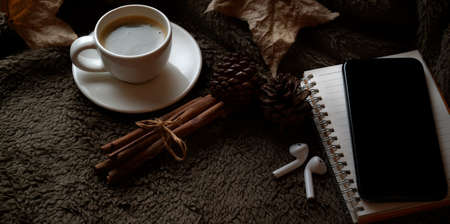 Vintage workspace with smartphone, coffee cup and office supplies on brown fur backgroundの写真素材