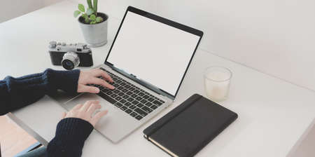 Cropped shot of female professional photographer working her project with blank screen laptop computer の写真素材
