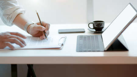 Cropped shot of professional businessman signing business contract in his office room の写真素材
