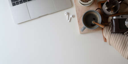 Top view of comfortable workspace with laptop computer and office supplies on white desk background and copy space の写真素材