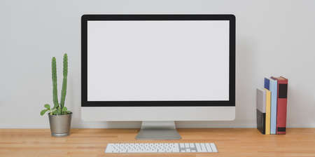 Mock up desktop computer in modern home-office room with office supplies on wooden table の写真素材