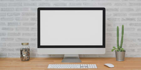 Mock up desktop computer in modern home-office room with office supplies on wooden table の写真素材