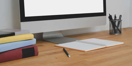 Close-up view of contemporary workspace with desktop computer and office supplies の写真素材
