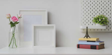 Comfortable workplace with mock up frame and copy space with camera and office supplies の写真素材