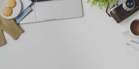 Top view of photographer comfortable workspace with office supplies on white table background with camera の写真素材