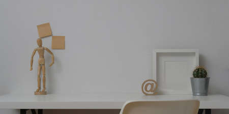 Minimal workspace with mock up frame and copy space with office supplies and decorations の写真素材