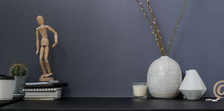 Contemporary workspace and copy space with office supplies and ceramic vase with grey wall background の写真素材