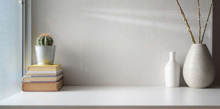 Minimal workspace with blank screen digital tablet and copy space with ceramic vase decorations の写真素材