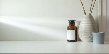 Minimal workspace with copy space and ceramic vase decorations and coffee cupの写真素材