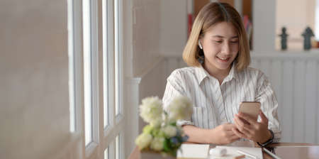 Professional young female designer working on her project with digital tablet in comfortable workspaceの写真素材