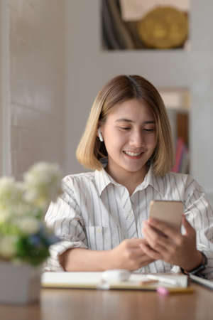 Professional young female designer working on her project with digital tablet in comfortable workspaceの写真素材