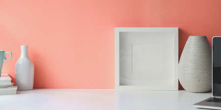 White frame mock up on white desk workspace and copy spaceの写真素材