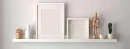 Mock up frame and decorations on shelf with white wall backgroundの写真素材