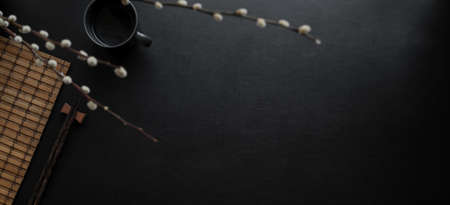 Top view of dark modern workspace with coffee cup and copy space on blank leather deskの写真素材