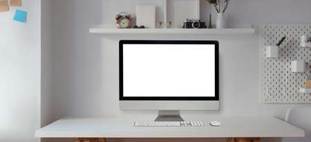 Blank screen desktop computer in modern office room with office supplies and decorations の写真素材