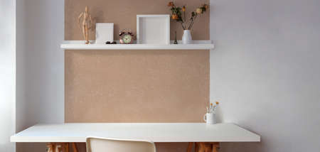 Vintage artist workspace with empty white wooden table and decorations on the shelf の写真素材