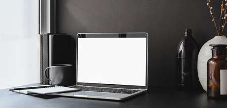 Modern office room with blank screen laptop computer and office supplies with decorationsの写真素材