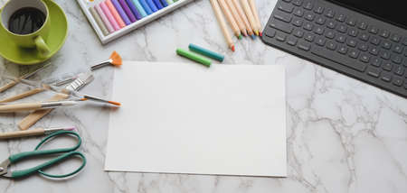 Top view of modern artist studio with office supplies and painting tools on marble desk backgroundの写真素材